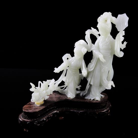 A Chinese pale celadon jade group of a lady and a girl with flowing robes, a basket beside them, 20th century, total height 19cm